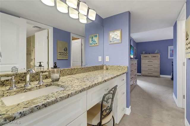 full bath featuring vanity, baseboards, and visible vents