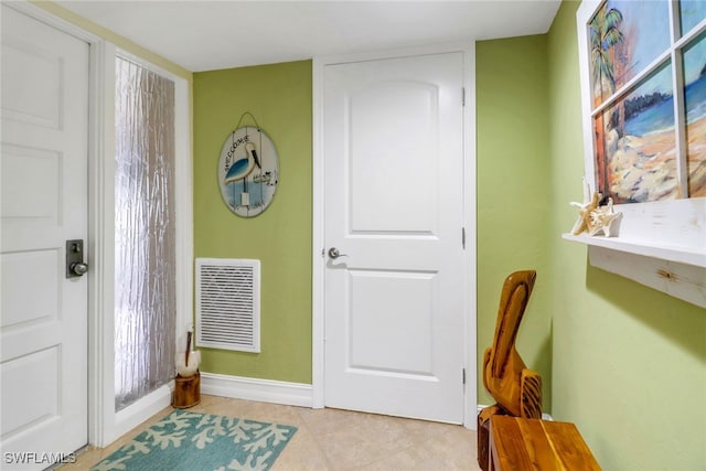 entryway with light tile patterned flooring, baseboards, and visible vents