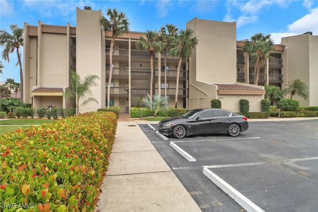 view of building exterior featuring uncovered parking