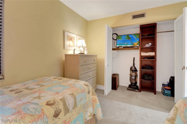 carpeted bedroom with visible vents and baseboards