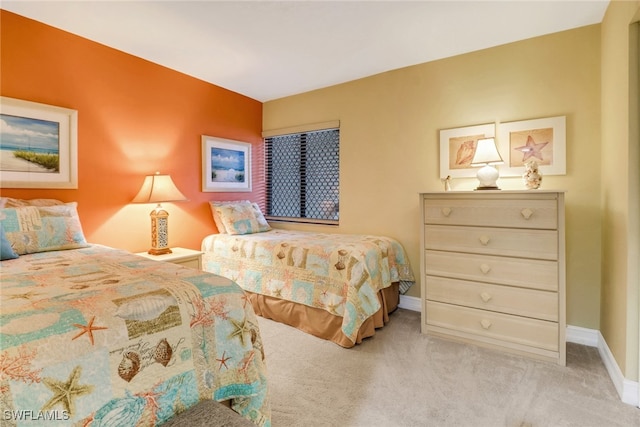 bedroom featuring baseboards and carpet flooring