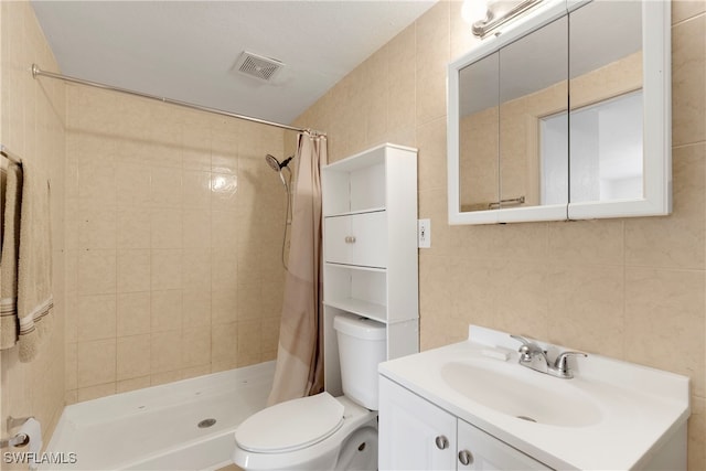 bathroom featuring vanity, walk in shower, tile walls, and toilet