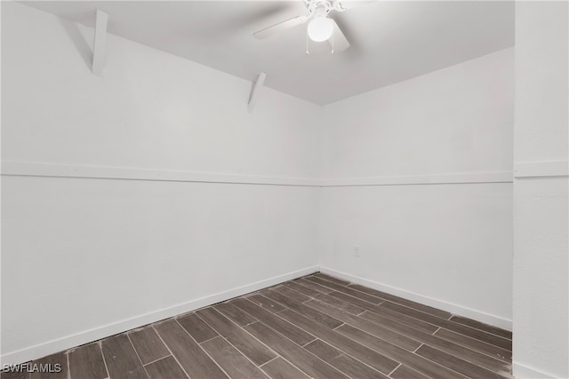 empty room with ceiling fan and dark hardwood / wood-style flooring