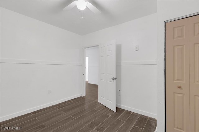 unfurnished bedroom featuring ceiling fan and dark hardwood / wood-style flooring