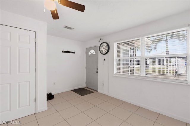 foyer featuring light tile patterned floors and ceiling fan