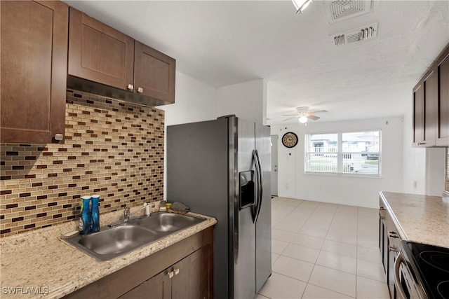 kitchen featuring stainless steel appliances, tasteful backsplash, sink, ceiling fan, and light tile patterned floors