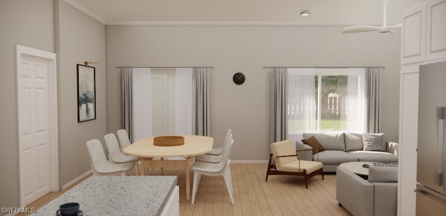 dining area featuring light wood-type flooring and ornamental molding