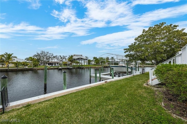 view of dock with a water view and a yard