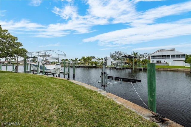 view of dock with a water view and a lawn