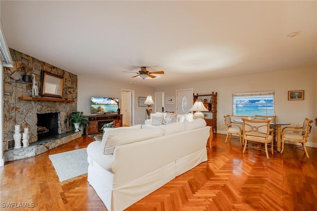 living room with a fireplace and ceiling fan