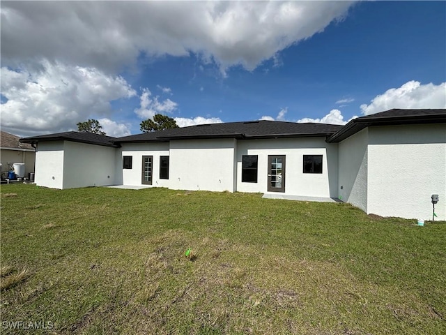 back of house featuring a patio and a lawn