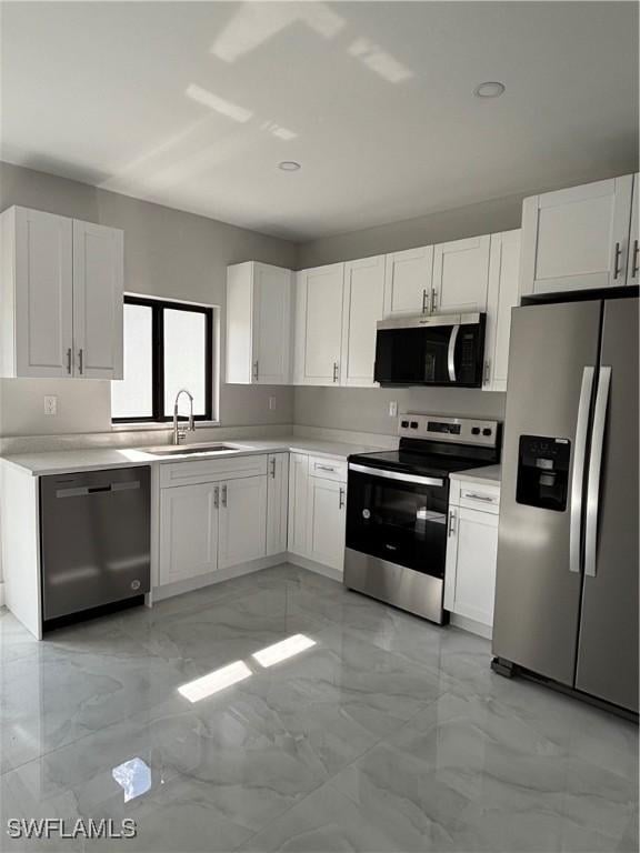 kitchen featuring white cabinetry, appliances with stainless steel finishes, and sink