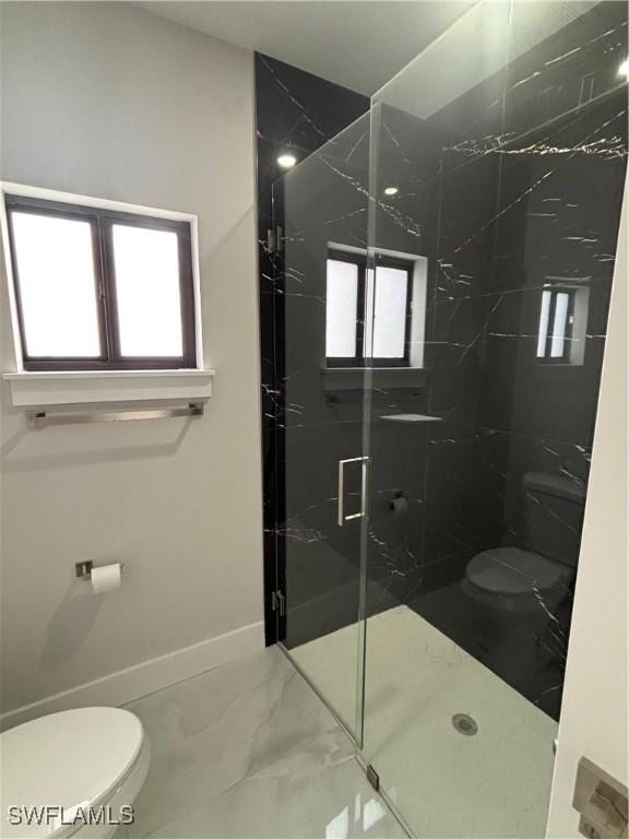 bathroom with toilet and an enclosed shower