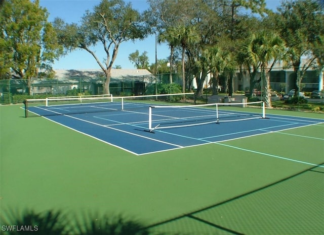 view of tennis court with fence