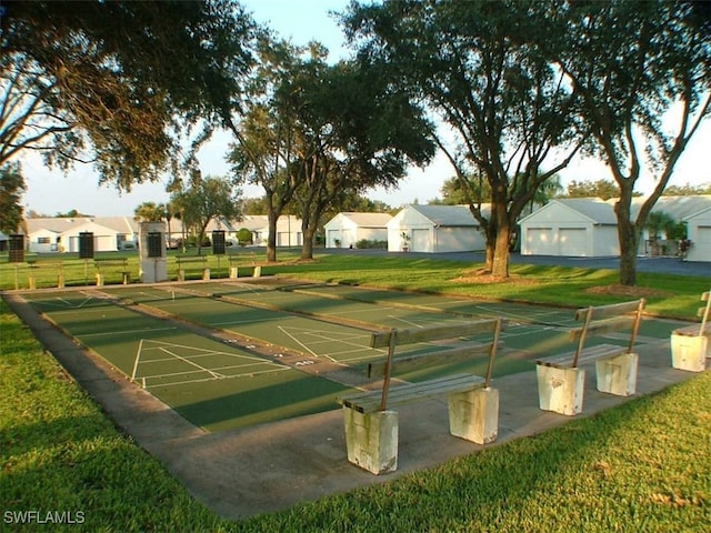 view of community featuring a residential view, a yard, and shuffleboard