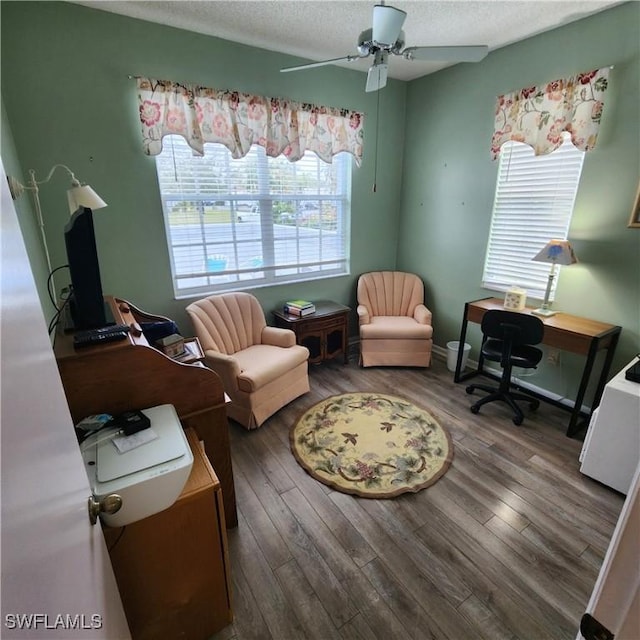 office with dark wood-style floors, a textured ceiling, and a ceiling fan