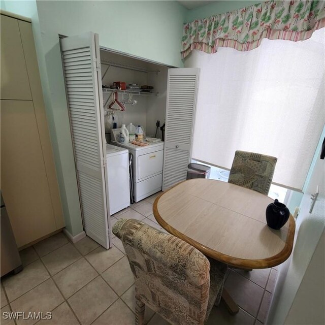 tiled dining space with separate washer and dryer