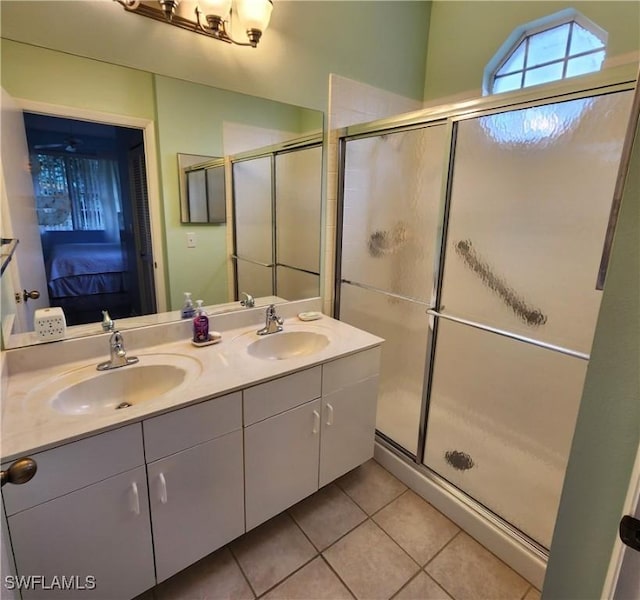 bathroom featuring vanity, walk in shower, and tile patterned flooring