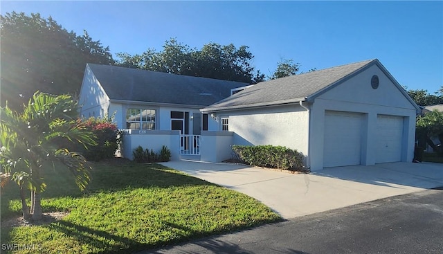 ranch-style house featuring concrete driveway, a front lawn, an attached garage, and stucco siding