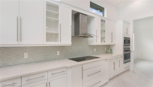 kitchen with white cabinetry, decorative backsplash, stainless steel appliances, and wall chimney exhaust hood