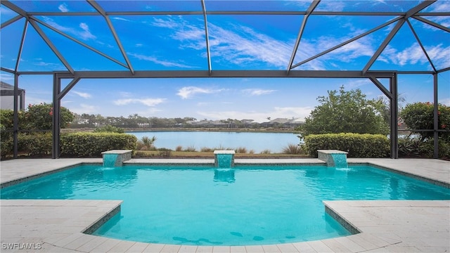 view of swimming pool featuring a patio area, pool water feature, glass enclosure, and a water view