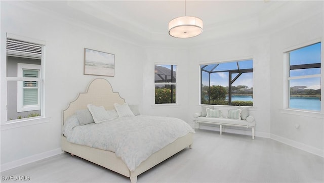 bedroom featuring concrete flooring, crown molding, and a water view