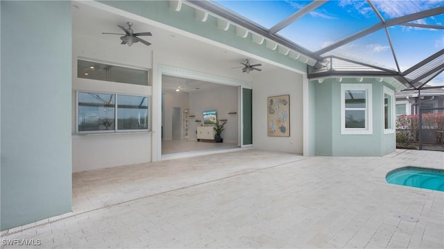 exterior space featuring ceiling fan and a lanai