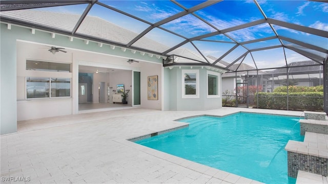 view of swimming pool featuring pool water feature, ceiling fan, a lanai, and a patio