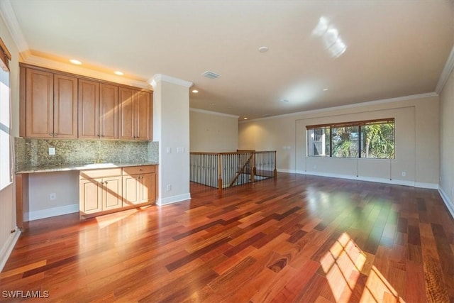 unfurnished living room with crown molding and dark hardwood / wood-style flooring