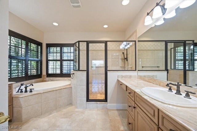 bathroom featuring vanity and separate shower and tub