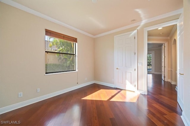 28830 Kiranicola Ct, Bonita Springs, FL 34135 - unfurnished room with dark wood-style floors, crown molding, baseboards, and arched walkways