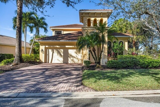 28830 Kiranicola Ct, Bonita Springs, FL 34135 - mediterranean / spanish-style house with decorative driveway, a garage, stucco siding, and a tiled roof