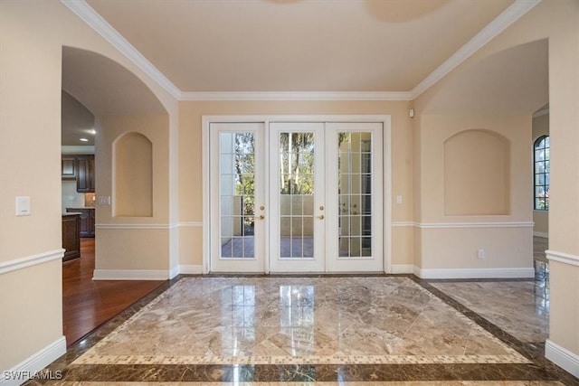 doorway with ornamental molding and french doors