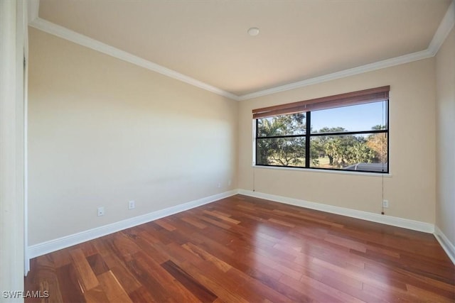 empty room featuring crown molding and dark hardwood / wood-style floors