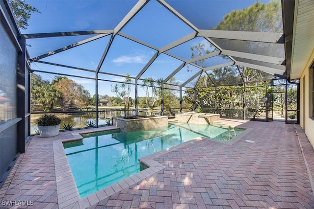 view of pool with an in ground hot tub, a water view, a lanai, and a patio