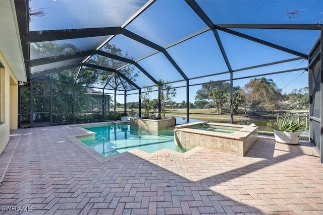 view of swimming pool featuring an in ground hot tub, a lanai, and a patio area