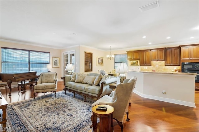 28830 Kiranicola Ct, Bonita Springs, FL 34135 - living area with dark wood-style flooring, plenty of natural light, crown molding, a chandelier, and recessed lighting