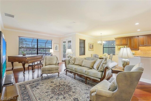 28830 Kiranicola Ct, Bonita Springs, FL 34135 - living room with wood finished floors, a chandelier, crown molding, and baseboards
