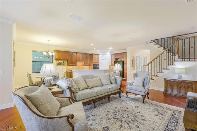 28830 Kiranicola Ct, Bonita Springs, FL 34135 - living area featuring baseboards, wood finished floors, stairs, a chandelier, and ornamental molding