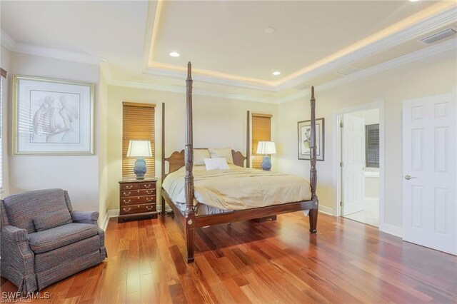 28830 Kiranicola Ct, Bonita Springs, FL 34135 - bedroom featuring a tray ceiling, wood finished floors, baseboards, recessed lighting, and ensuite bathroom