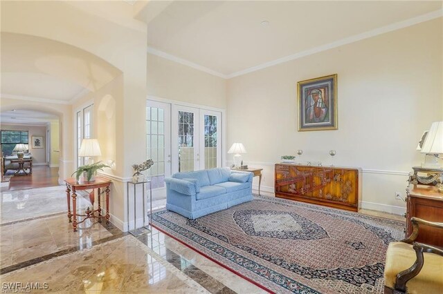 28830 Kiranicola Ct, Bonita Springs, FL 34135 - living area with arched walkways, french doors, crown molding, marble tiled floors, and baseboards