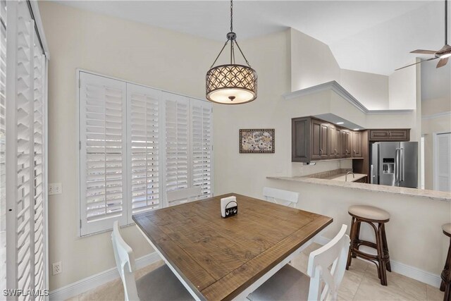 744 Belville Blvd, Naples, FL 34104 - tiled dining room featuring ceiling fan and a towering ceiling