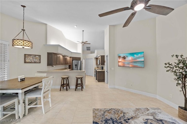 744 Belville Blvd, Naples, FL 34104 - tiled dining space with high vaulted ceiling and ceiling fan