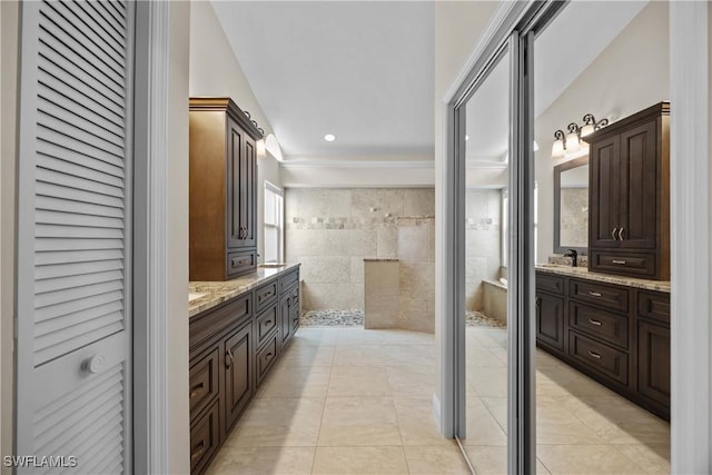 744 Belville Blvd, Naples, FL 34104 - bathroom with walk in shower, tile patterned floors, vanity, and tile walls