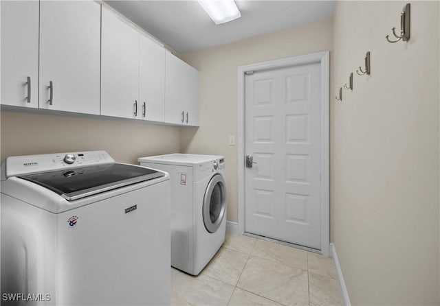 744 Belville Blvd, Naples, FL 34104 - laundry room featuring cabinets, separate washer and dryer, and light tile patterned floors