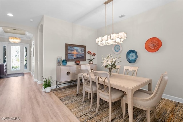 dining space with an inviting chandelier and hardwood / wood-style floors