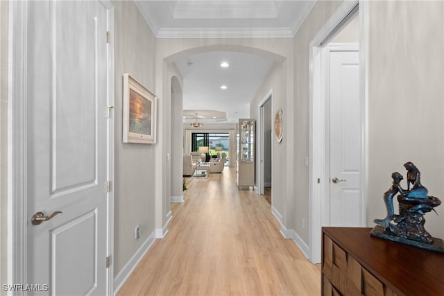 corridor featuring ornamental molding and light hardwood / wood-style floors