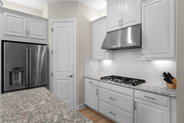 kitchen with white cabinetry, tasteful backsplash, and stainless steel appliances