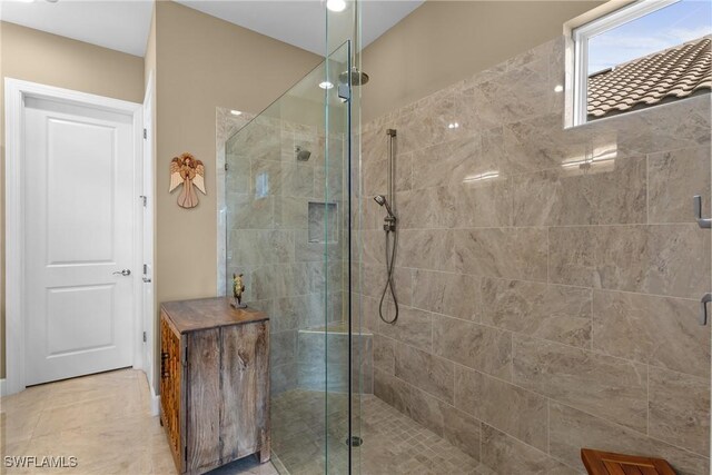 bathroom featuring a shower with shower door