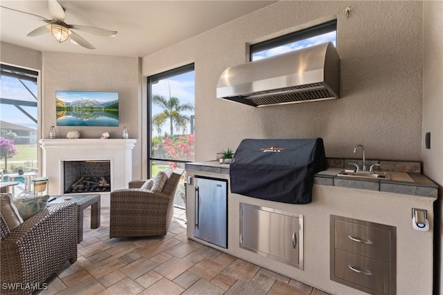 view of patio featuring area for grilling, sink, a grill, and ceiling fan